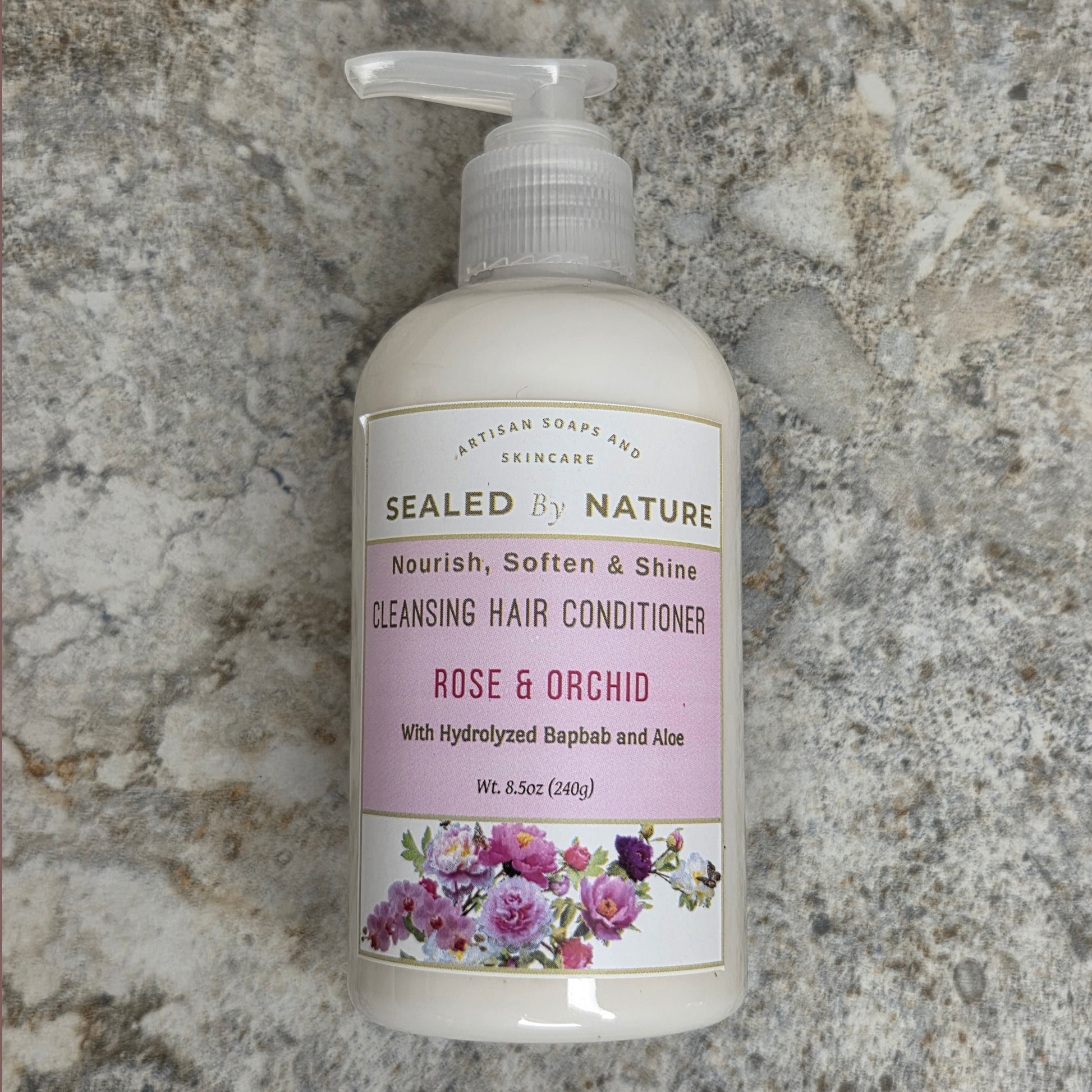 Bottle of Sealed by Nature cleansing hair conditioner on a marble surface