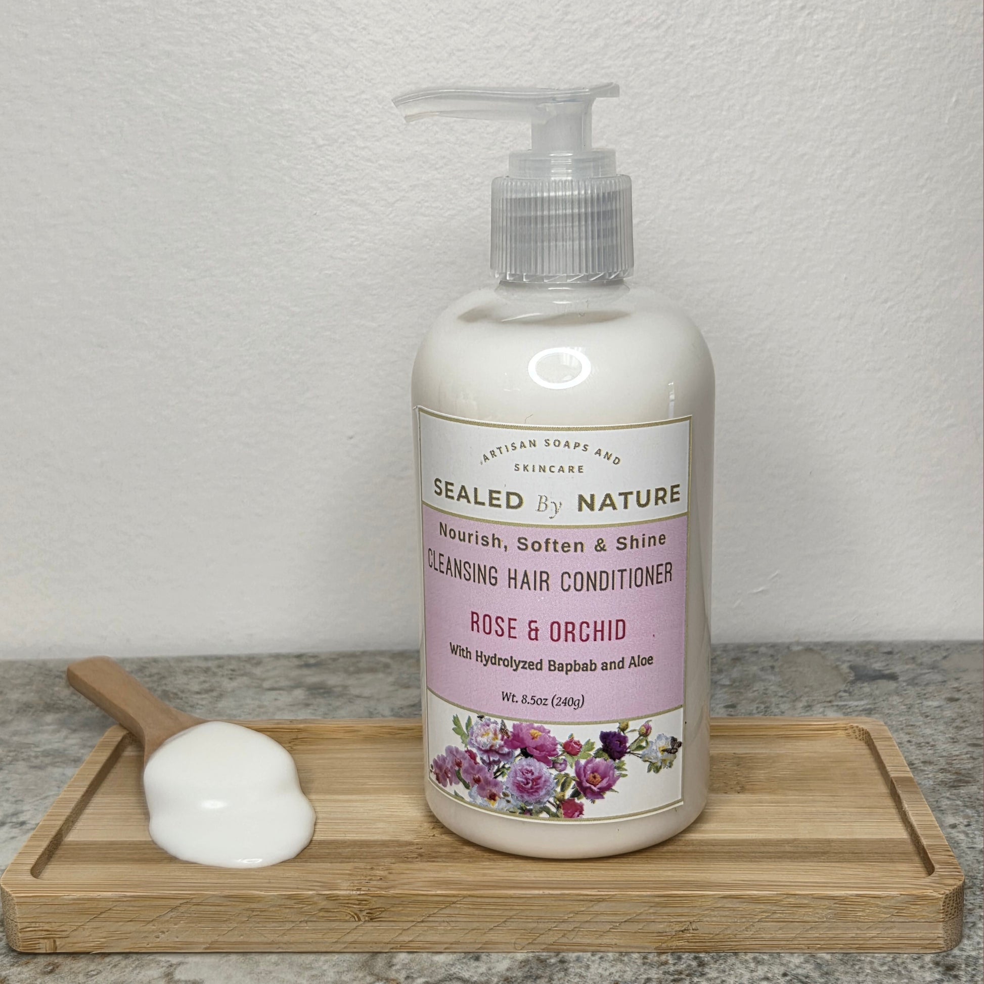 Bottle of Rose & Orchid Cleansing Hair Conditioner with pump, a creamy floral formula enriched with aloe vera and rose oil for silky, shiny hair.