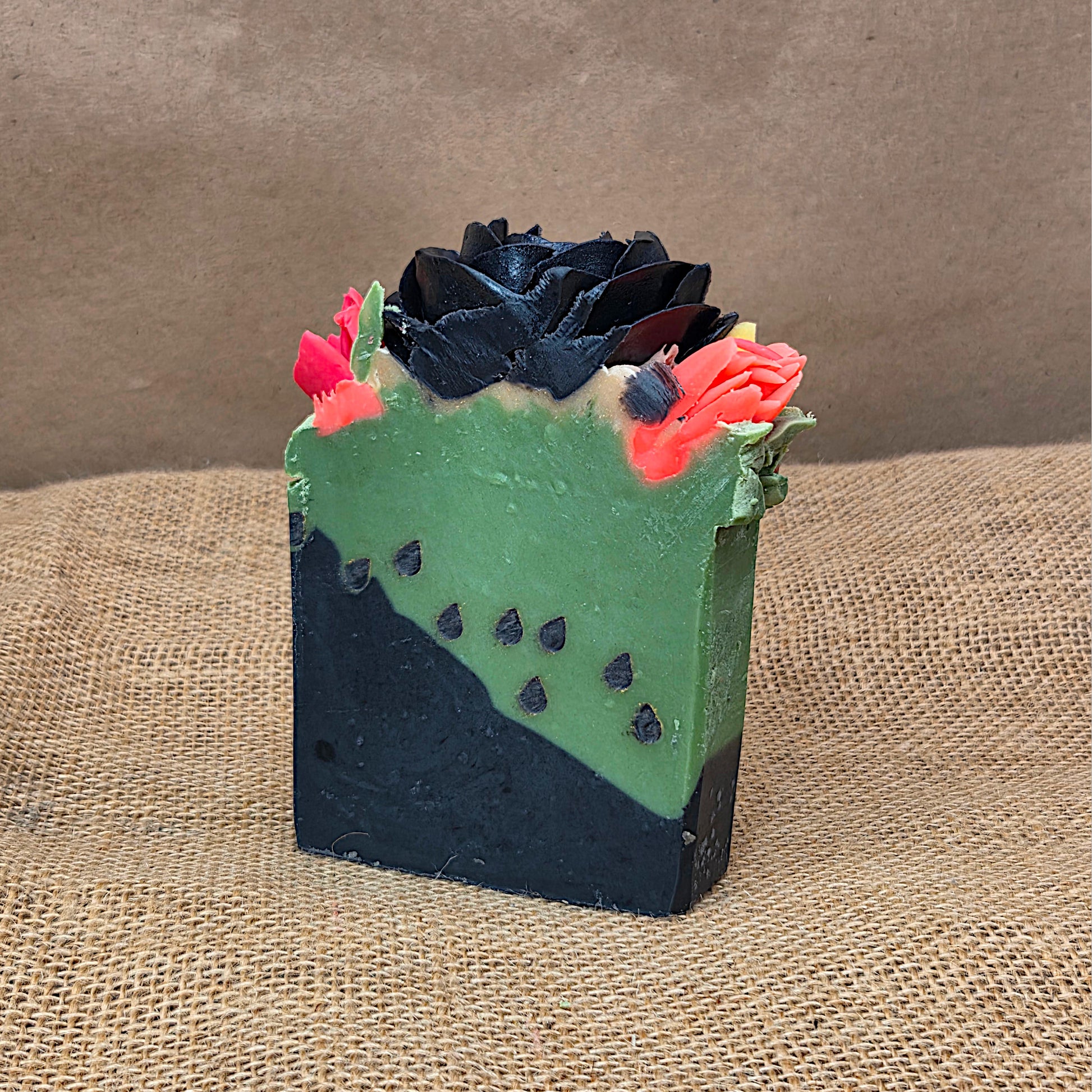 Bar of soap with a decorative top on a textured surface