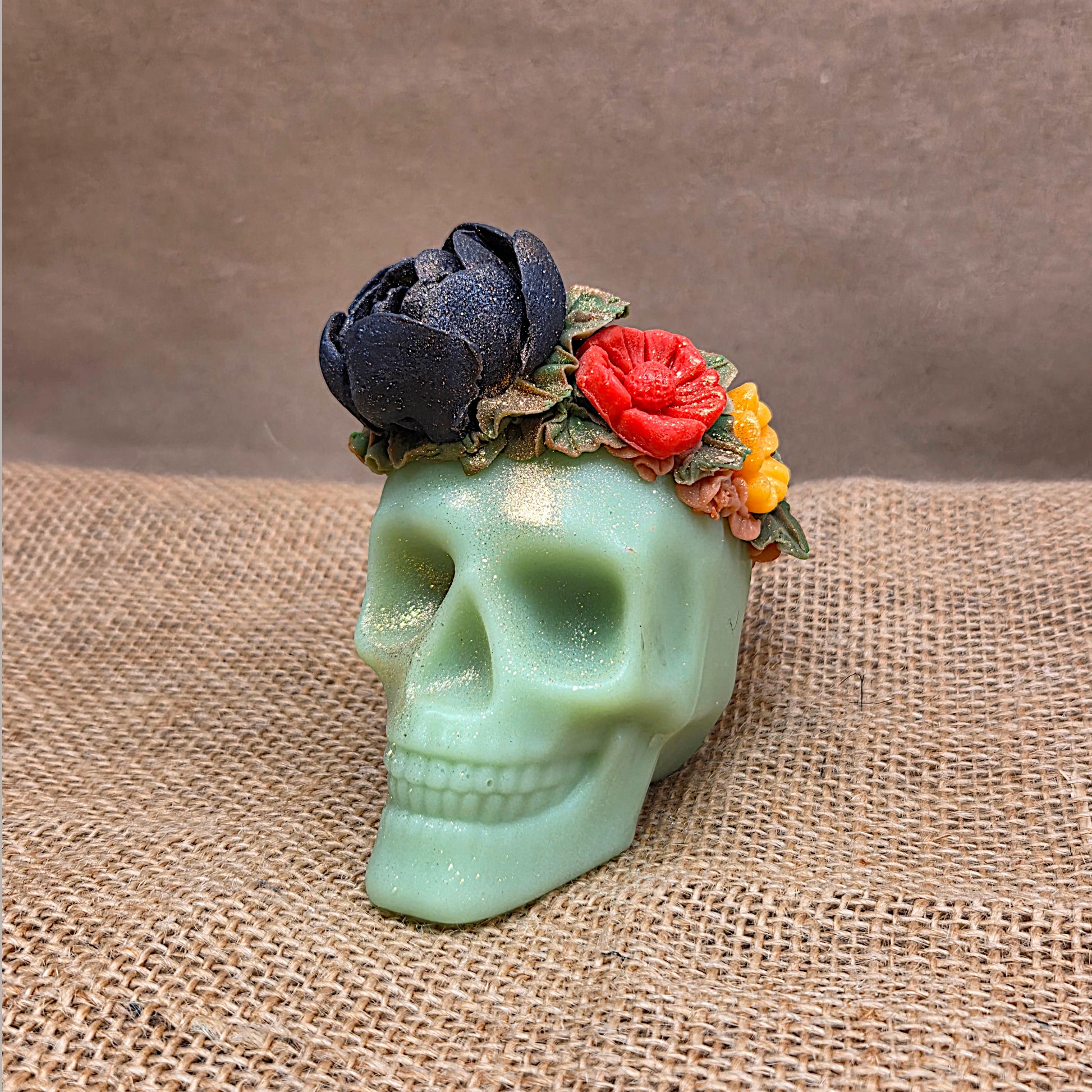 green skull in front of brown paper