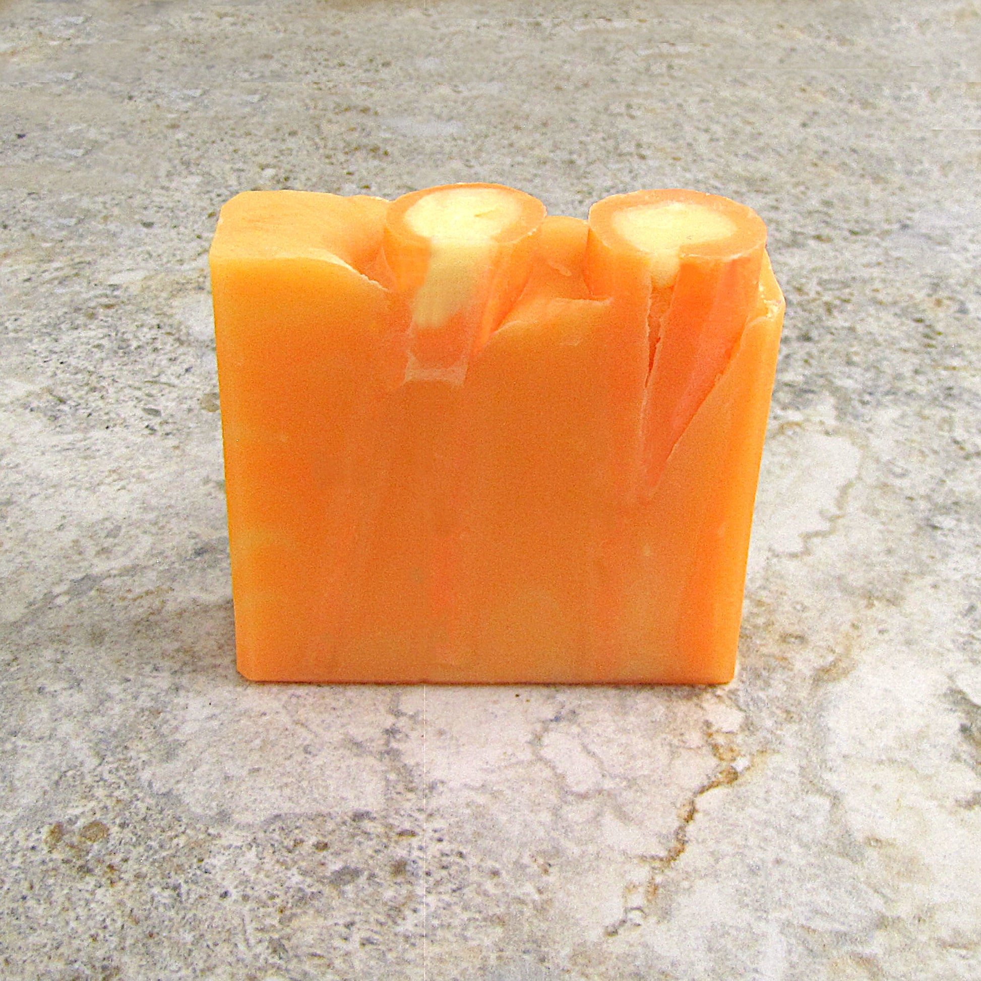 Orange colored soap bar with as citrus scent.