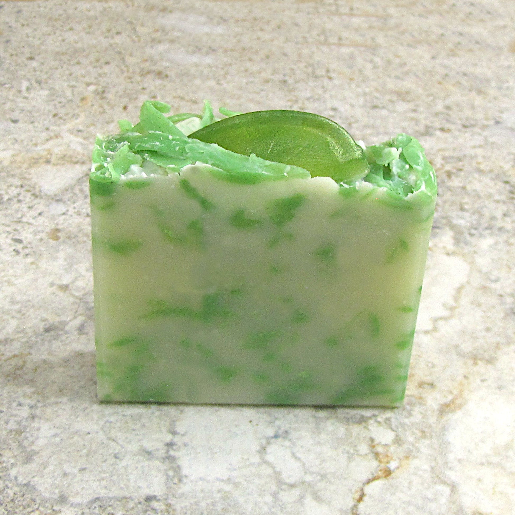 Mint Mojito Soap bar with a lime slice on top.