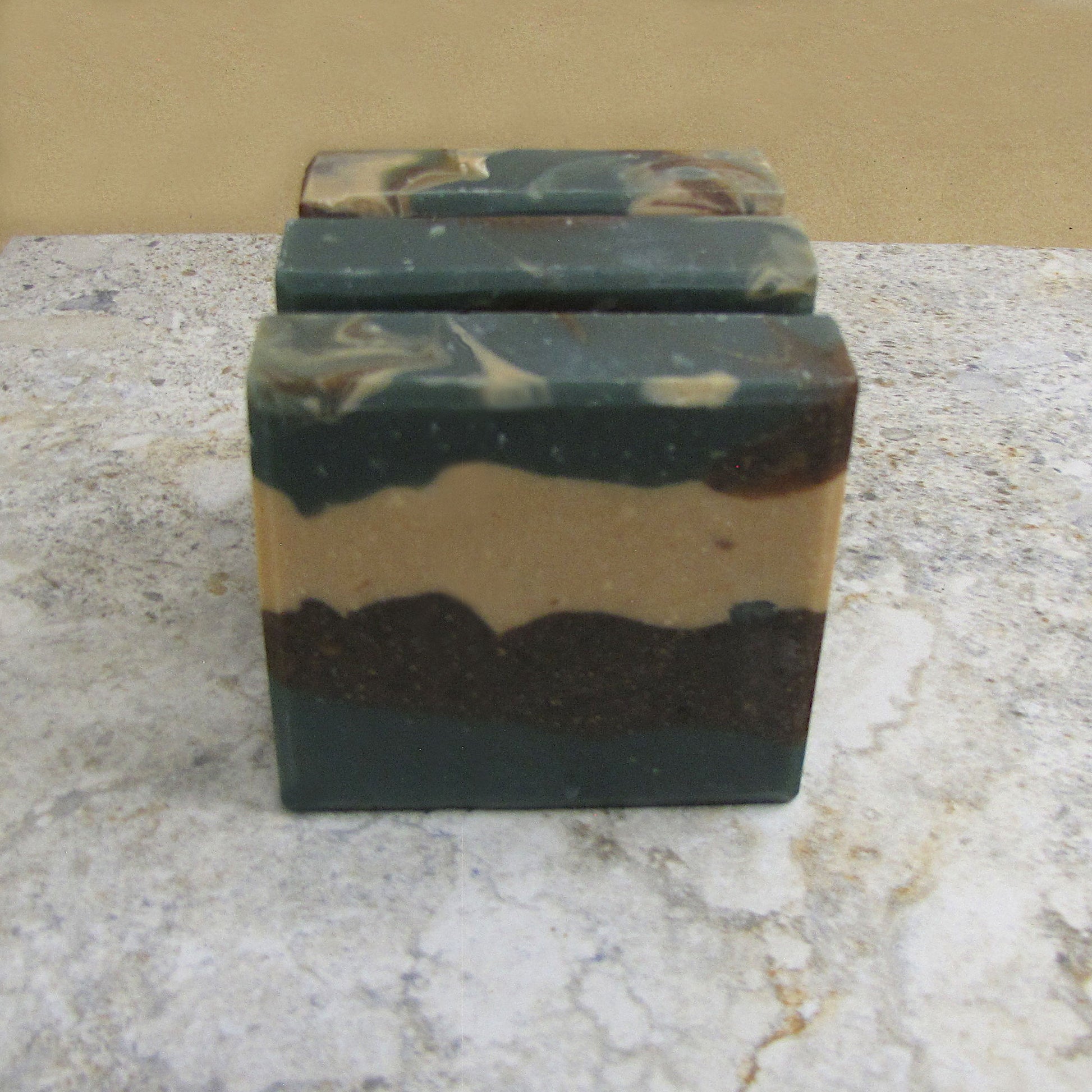 Elderberry tea and sage soap bars with layers of brown, tan and dark turquoise.