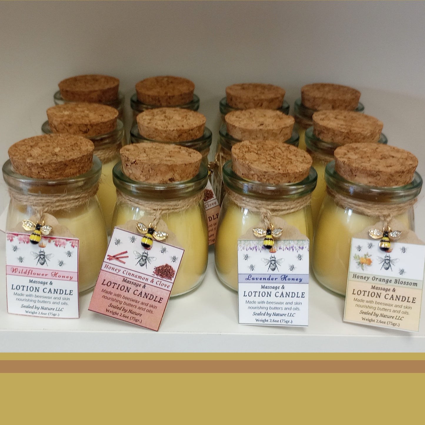 Honey scented lotion candles on the shelf with four complementary scents - lavender, wildflower, orange and cinnamon clove.