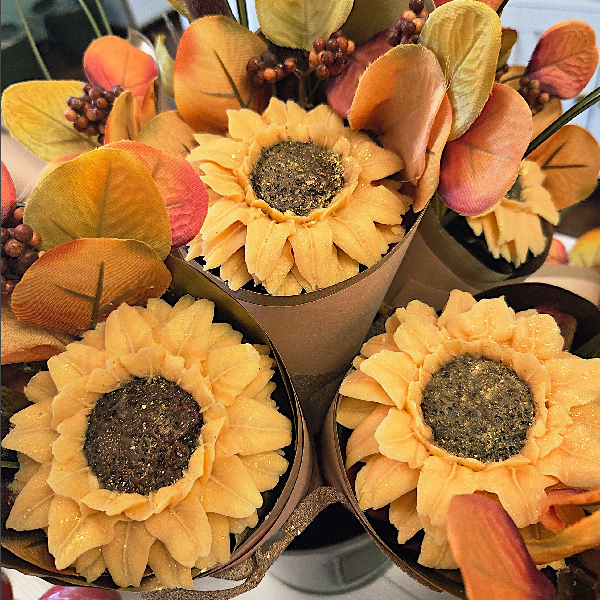 Decorative sunflower and leaf arrangement with a focus on yellow flowers.