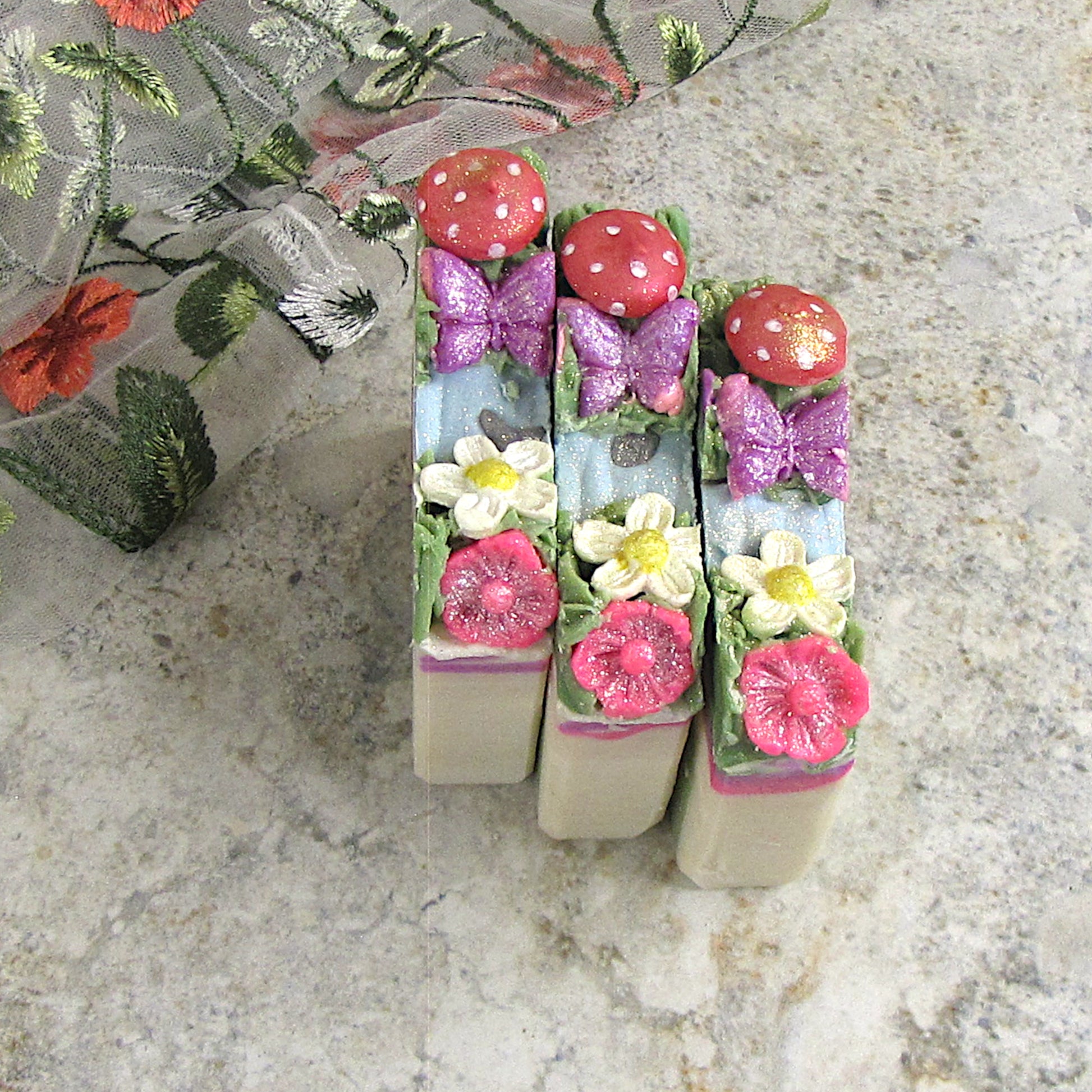 Artistic Soap bar -  Fairy Garden Home. Red mushroom, buterfly and flower embeds on top of the bar.