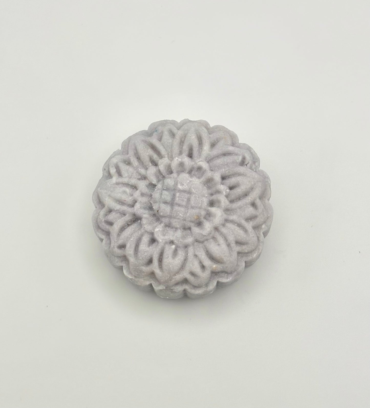 Lavender floral-patterned shampoo bar on a light gray background