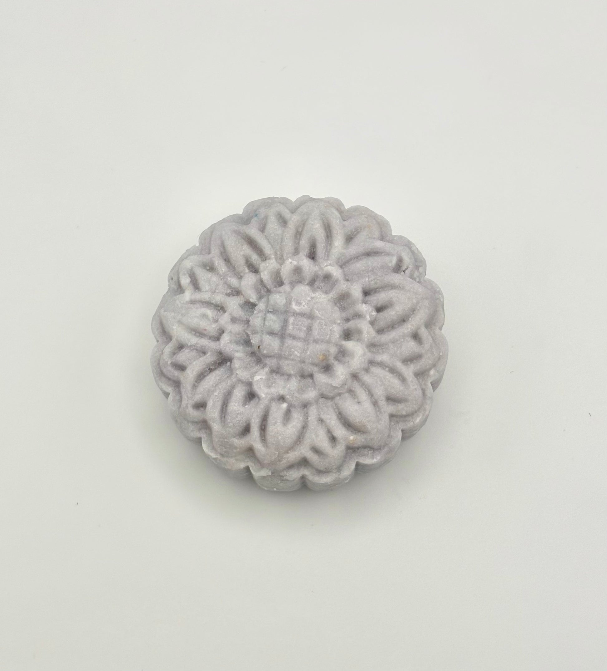 Lavender floral-patterned shampoo bar on a light gray background