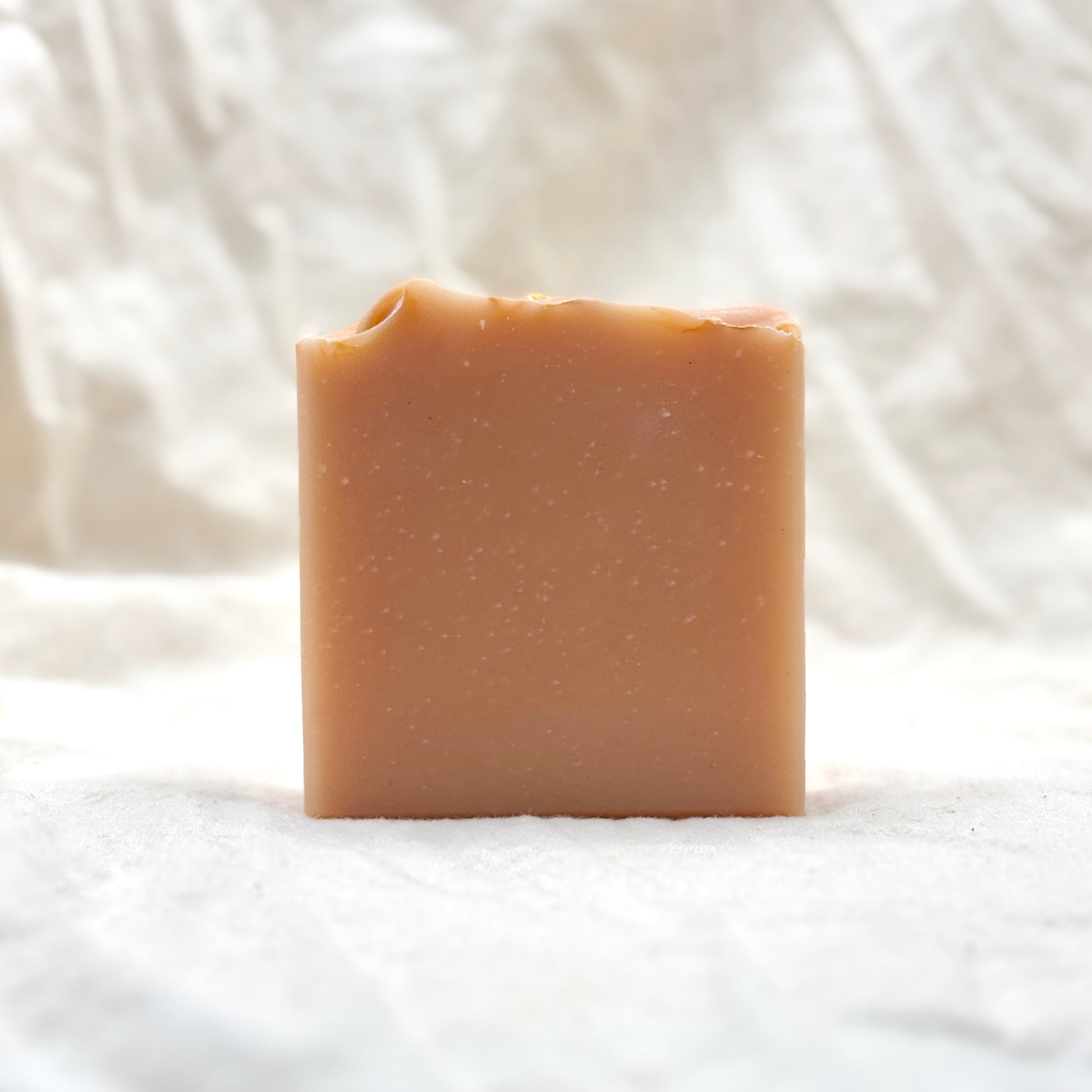 Bar of soap on a white fabric background