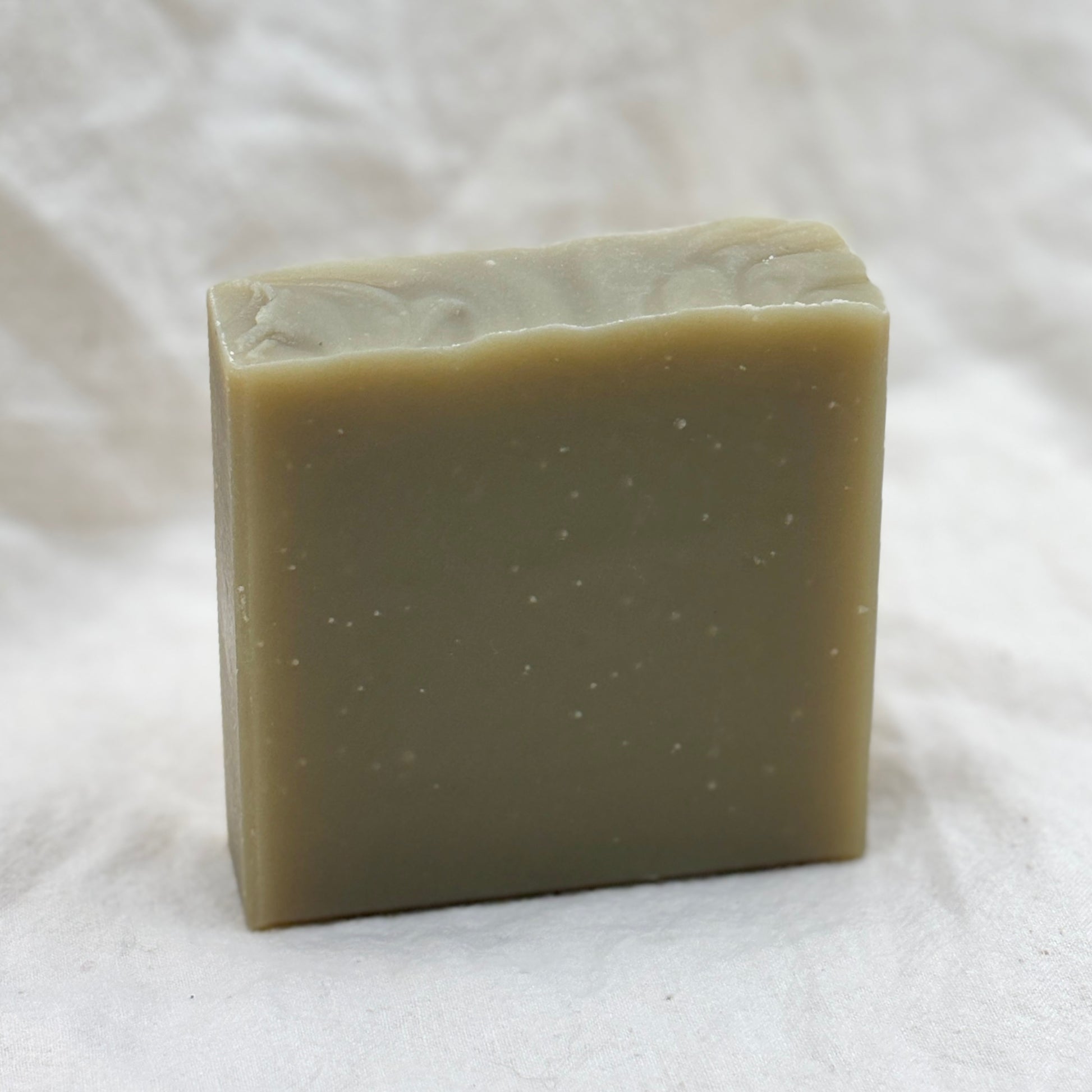 Bar of soap on a white fabric background