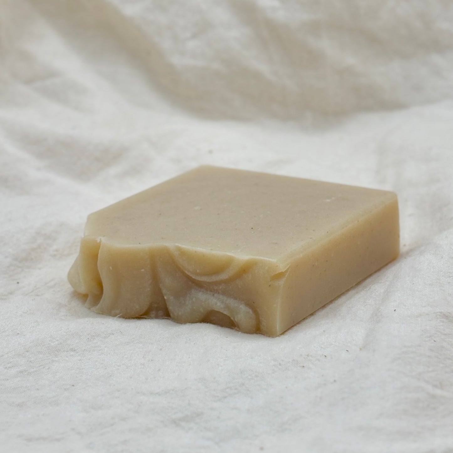 Bar of soap on a white fabric background
