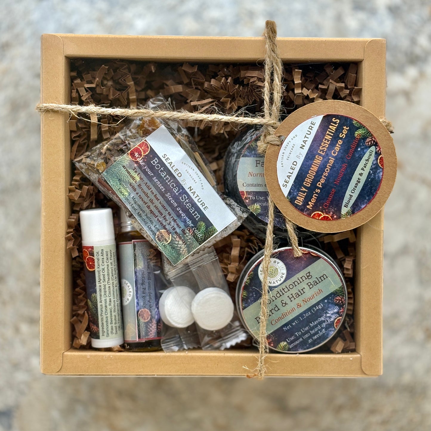 Box of Daily Grooming natural skincare products with labels on a neutral background