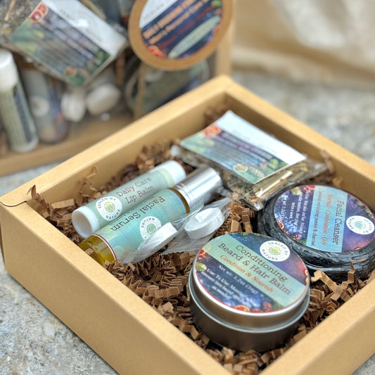 Assorted Men's personal care products in a cardboard box with brown filler