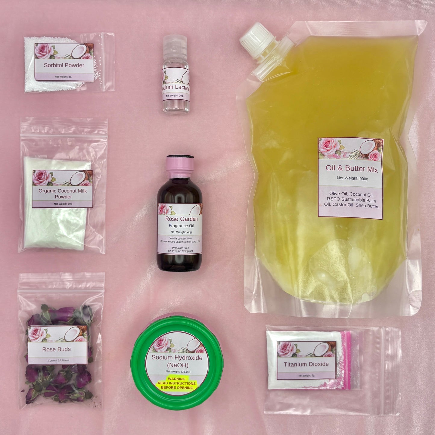 Contents of Cold Process Soap Making kit on a pink surface.
