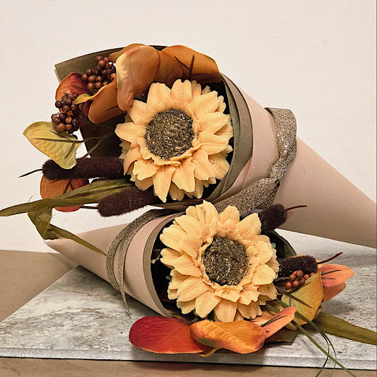 Bouquet of sunflowers with autumn leaves and berries on a neutral background