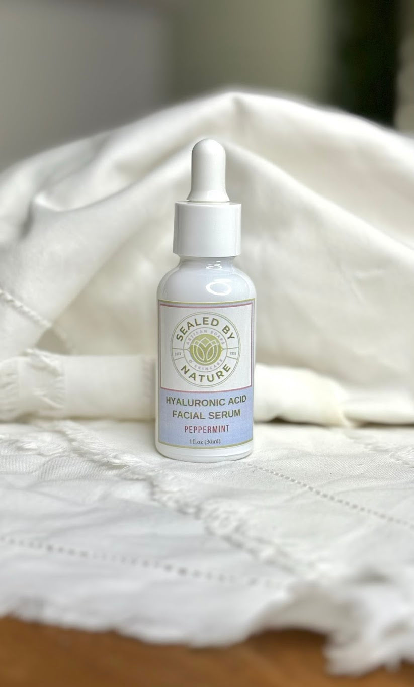 Peppermint facial serum bottle labeled 'Sealed by Nature' on a white textured surface